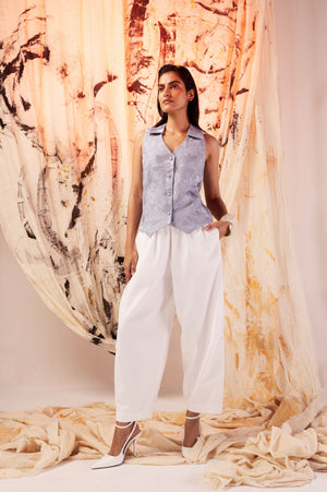 Luxurious white cotton twill trousers with a balloon silhouette, elasticated waist, and side pockets, offering a modern, relaxed fit