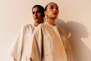 Elegant white cotton satin shirt with a Mandarin collar, kimono-style pleated sleeves, and subtle crystal embellishments, handcrafted in India