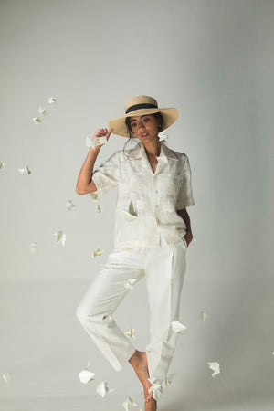 Luxurious white linen silk jacquard trousers, relaxed straight fit with pockets, artisan-crafted for comfort and elegance in womenswear