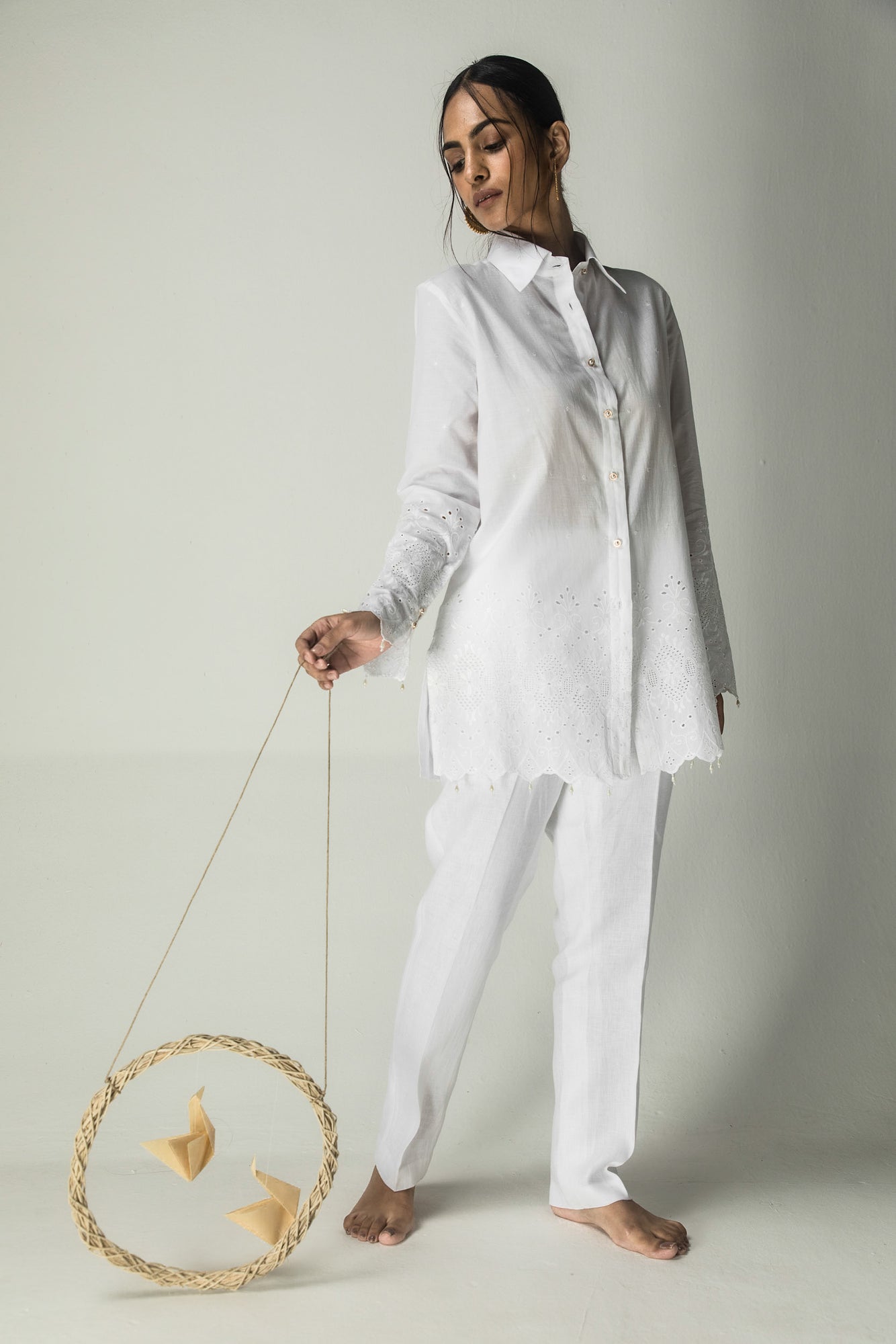 Elegant white cotton mulmul shirt with lace-detailed placket, organic linen stripes, and intricate cutwork on sleeves and hem