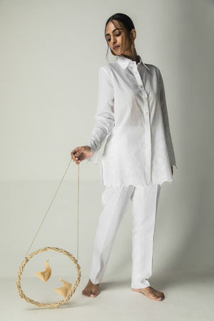 Elegant white cotton mulmul shirt with lace-detailed placket, organic linen stripes, and intricate cutwork on sleeves and hem