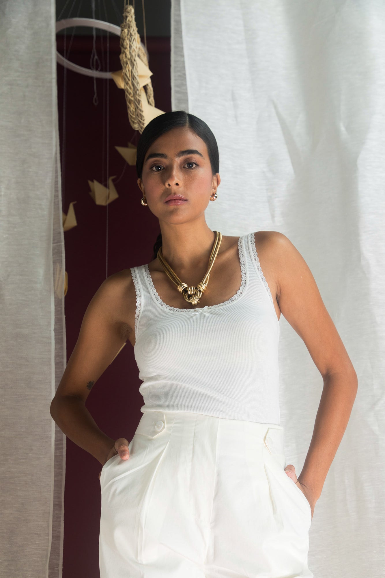 White Italian cotton silk trousers with a narrow, loose fit and button details, embodying handcrafted luxury and artisan elegance