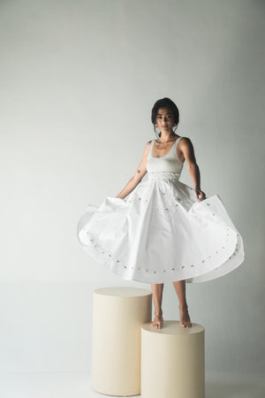 White cotton poplin skirt with delicate thread embellishments, showcasing luxury womenswear craftsmanship and a refined, elegant silhouette
