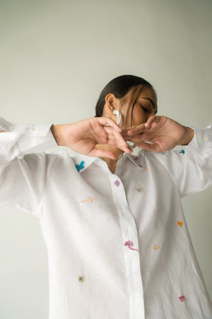 White linen shirt with artisan doodle patchwork, crafted from premium Italian fabric, exuding luxury and elegance in womenswear