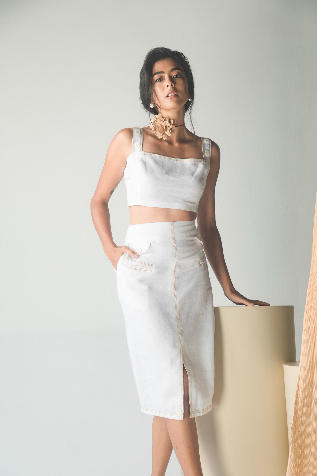 Luxurious Italian white linen co-ord set featuring a loose-fitted crop top and pencil skirt with artisan denim stitch details in crisp white