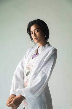 Elegant white midi dress in premium Italian linen with intricate pearl and thread embroidery, showcasing luxury artisan craftsmanship