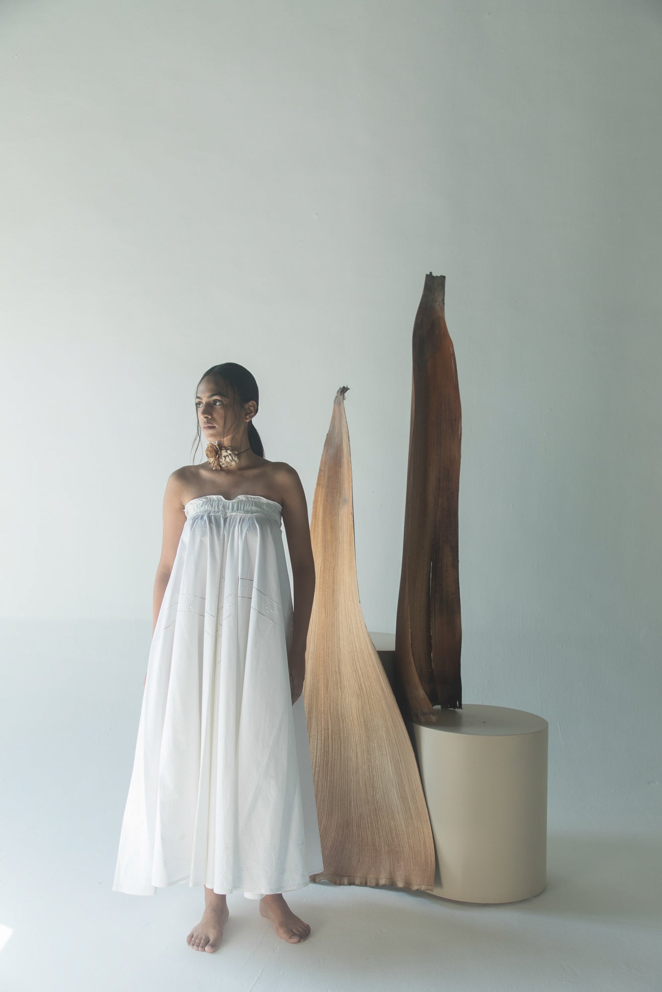Elegant white ankle-length skirt in crisp Italian cotton, featuring an elastic ruffled waist, epitomizing luxury womenswear craftsmanship
