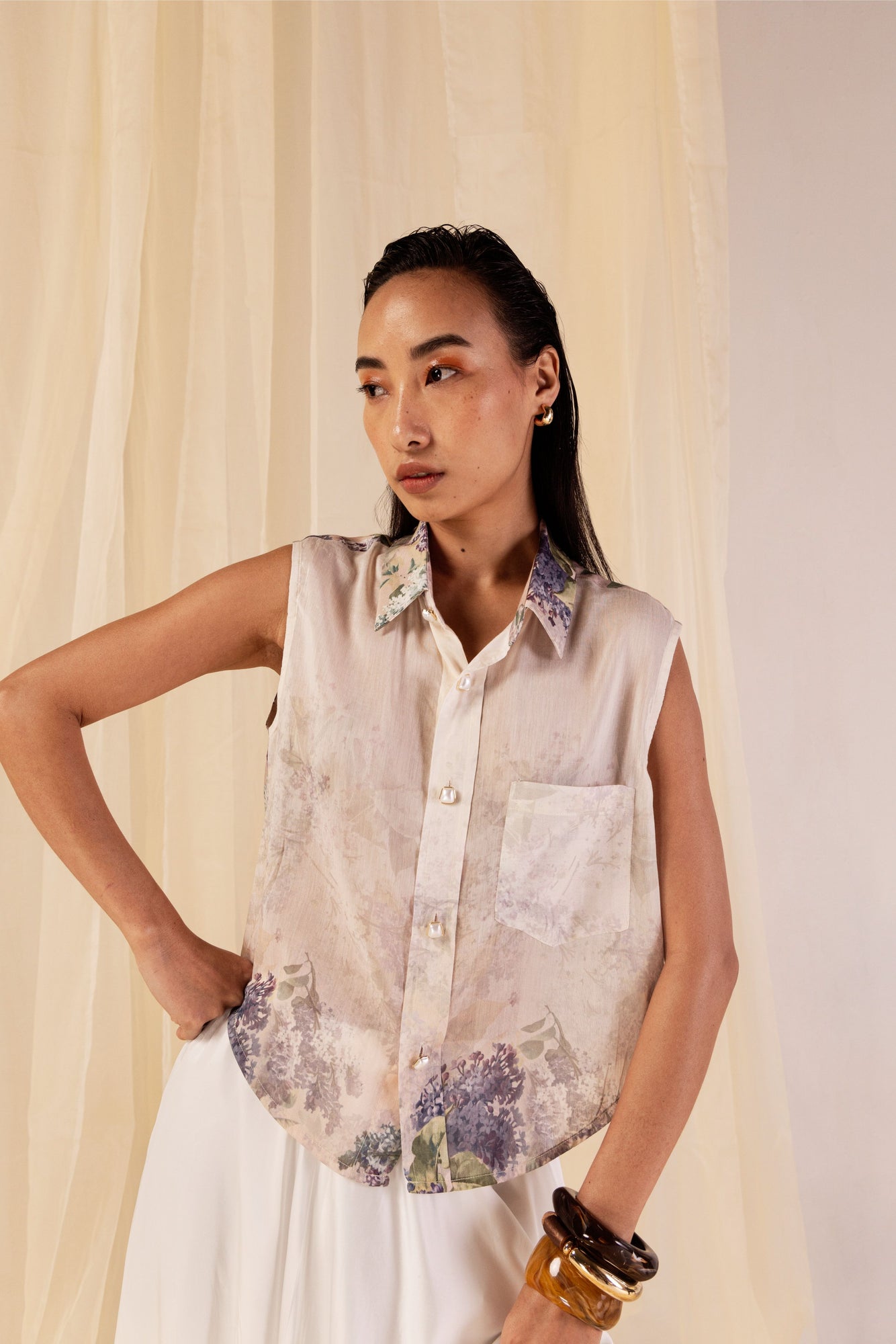 Sleeveless shirt in Hydra Hues print, crafted from Chanderi silk with a classic collar, pearl buttons, and a front pocket; artisan-made in India