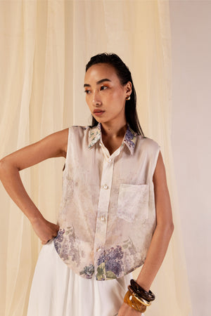 Sleeveless shirt in Hydra Hues print, crafted from Chanderi silk with a classic collar, pearl buttons, and a front pocket; artisan-made in India