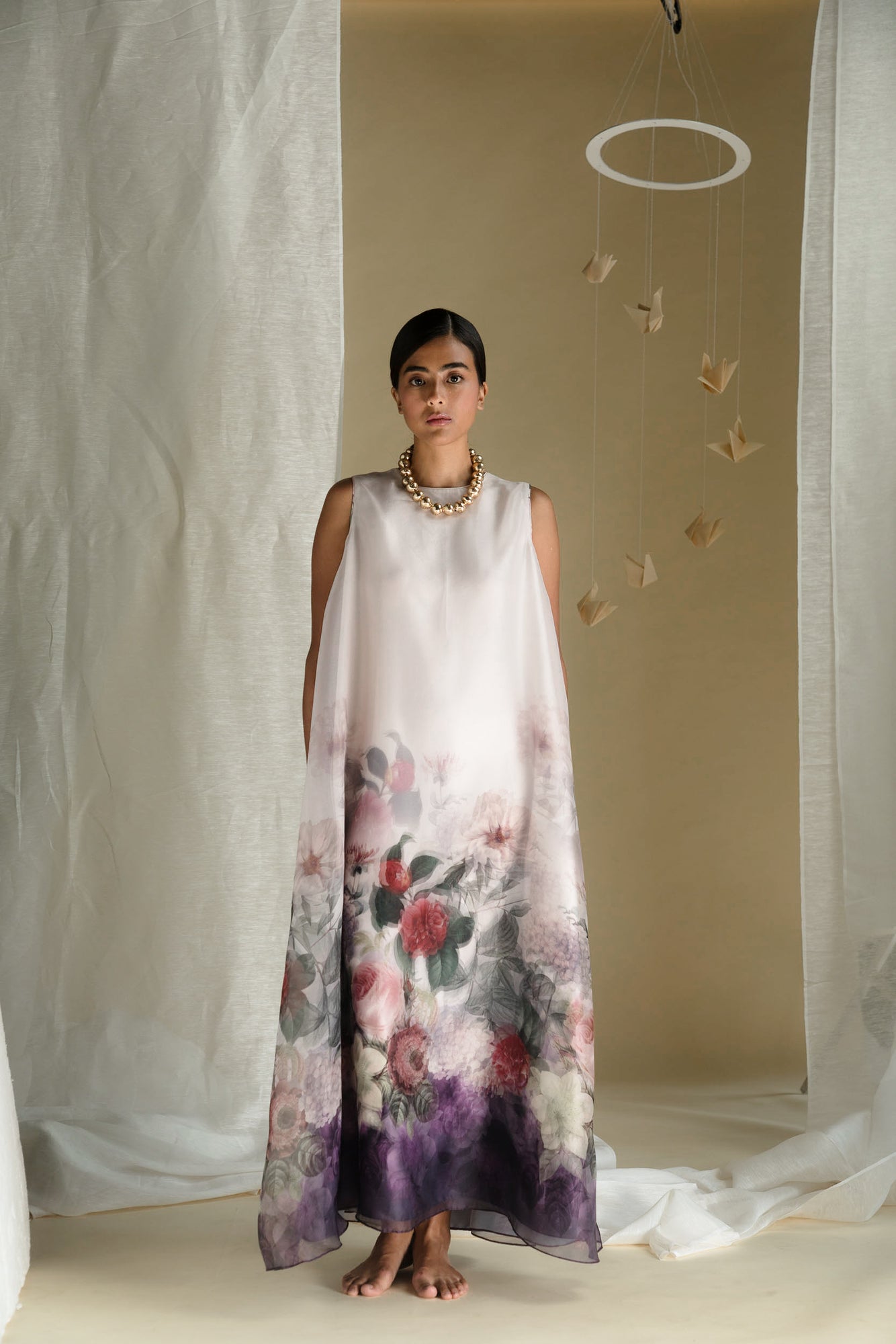 Sleeveless long dress in printed silk organza and samo satin, featuring a zero neckline and shadow print in off-white, purple, and beige