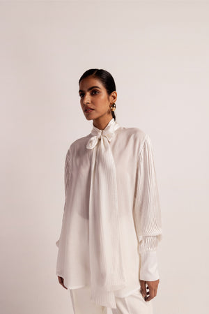 Luxurious orange stripe shirt with Bemberg satin sleeves, scarf-like front, and intricate pin tucks; handcrafted elegance in womenswear