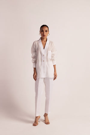 Luxurious orange peel and linen shirt with pin-tuck details, shawl collar, pearl buttons, and full sleeves, showcasing artisan craftsmanship