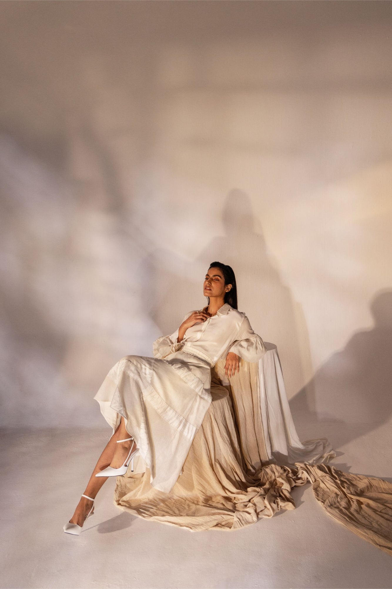 Luxurious almond beige skirt with diagonal pleats, crystal accents, and an elasticated waist, crafted from premium Bemberg satin