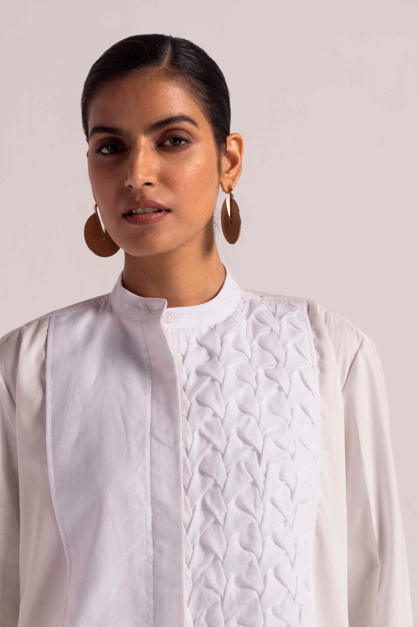 Luxurious linen shirt with hand-smocked yoke, mandarin collar, and full sleeves. Crafted from premium cotton satin and linen. Artisan-made