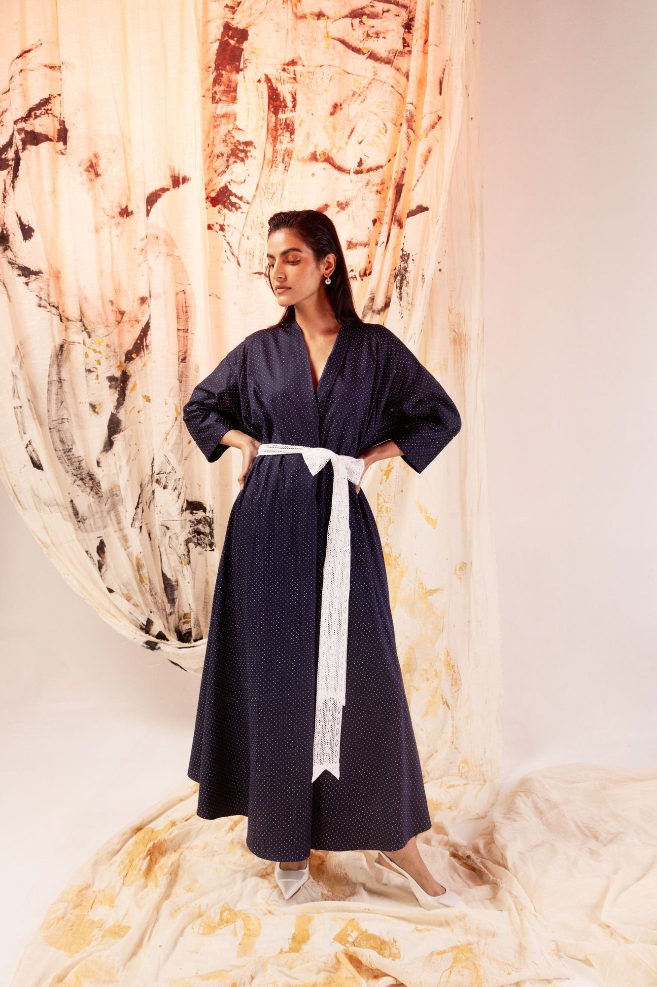 Luxurious blue polka dot sateen dress with kimono sleeves, V-neck, lace belt, and crystal embellishments, crafted in India