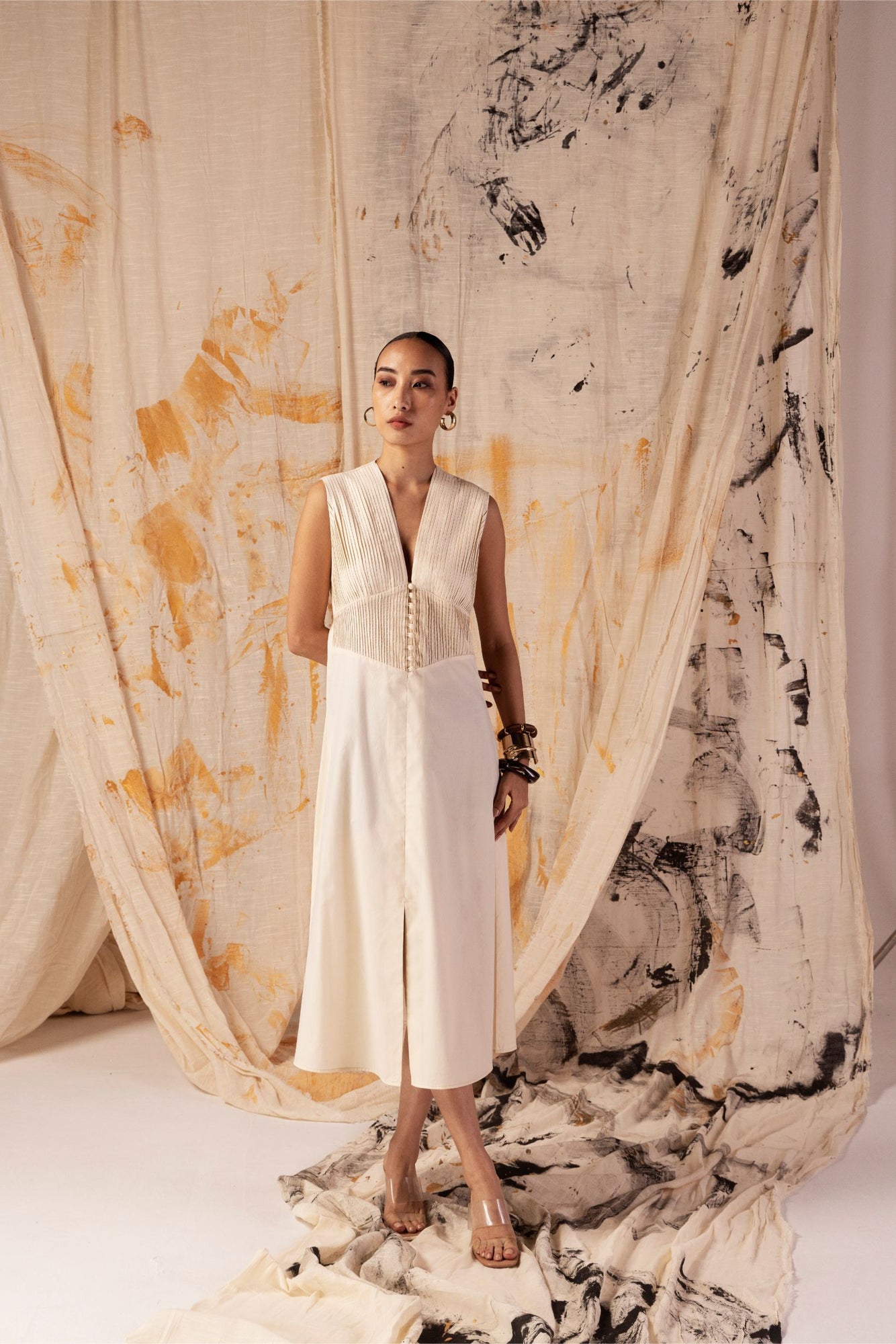 Sleeveless yellow dress in Italian cotton with V-neck, pleated yoke, pin-tucked waist, front slit, and button-front, exuding luxury and elegance
