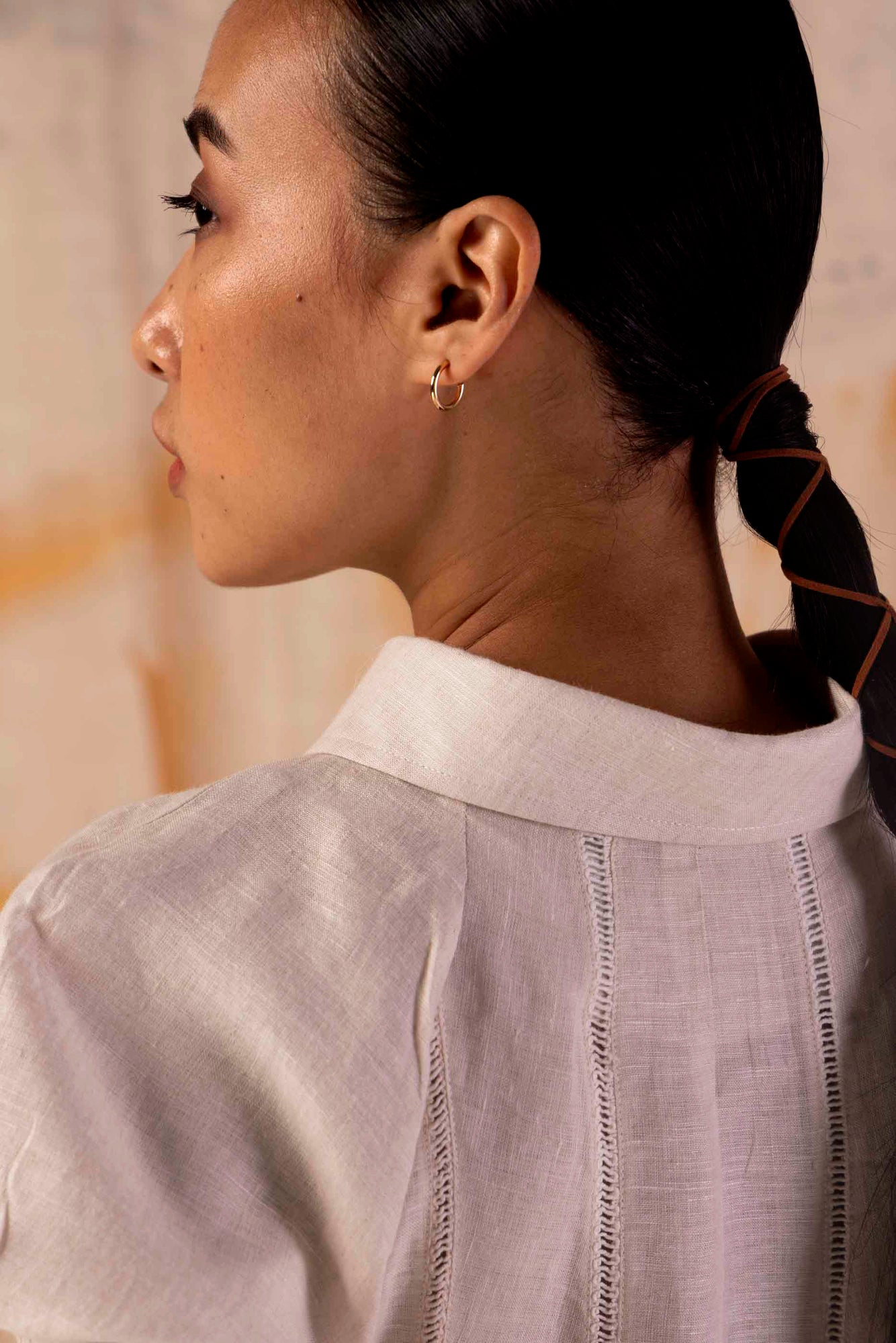 Elegant sand-hued linen dress showcasing handloom craftsmanship, featuring a flowing silhouette and luxurious, artisan-made design