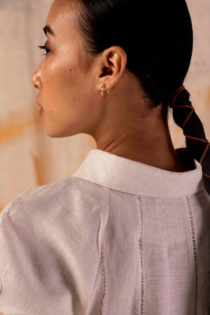 Elegant sand-hued linen dress showcasing handloom craftsmanship, featuring a flowing silhouette and luxurious, artisan-made design