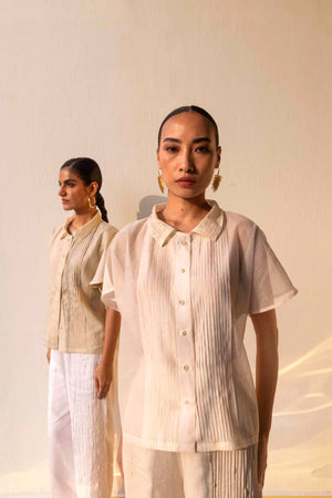 Elegant sheer Chanderi silk shirt with lace collar, pin tuck details, half sleeves, and button closure, showcasing luxury womenswear craftsmanship
