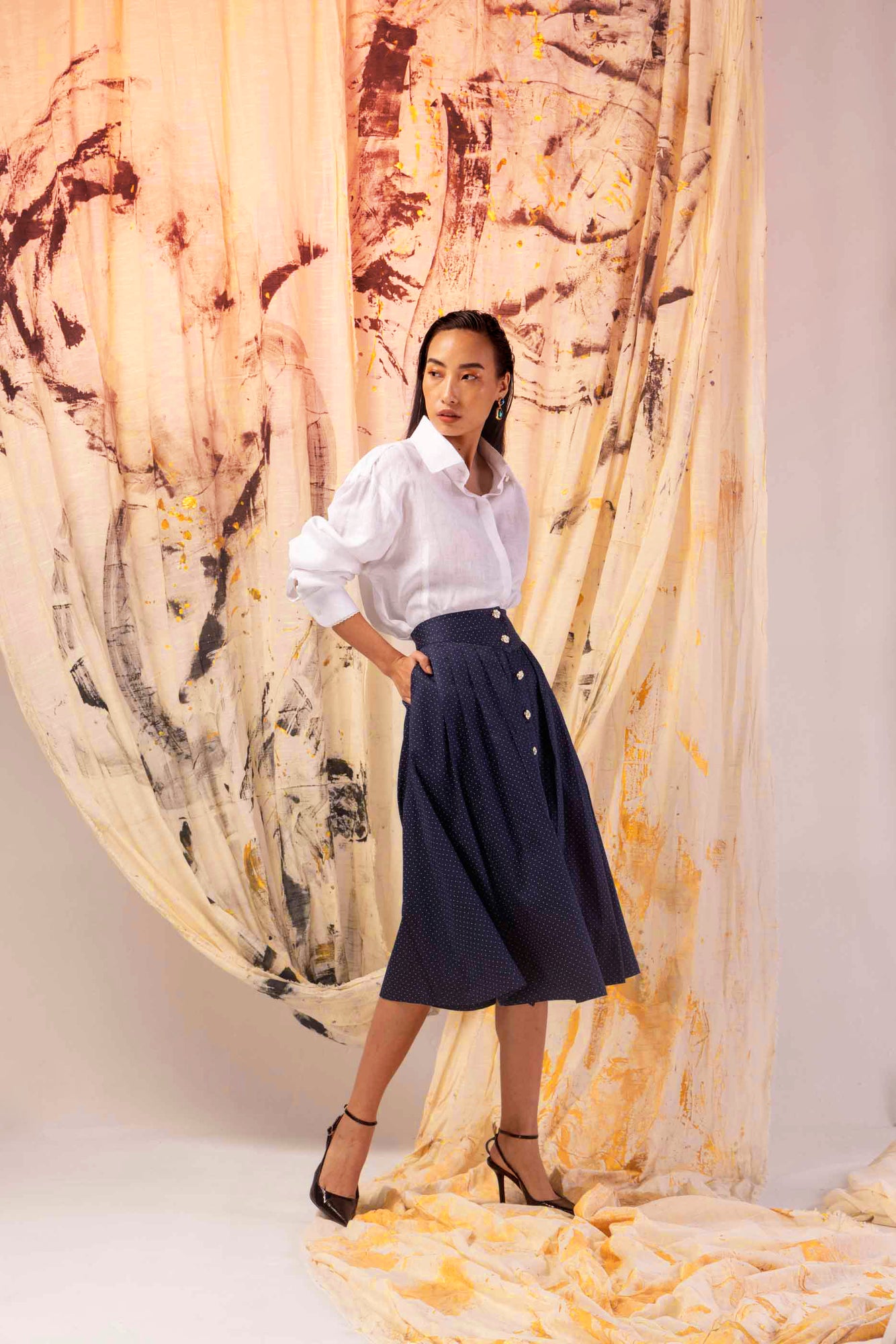 Azure skirt with delicate pearl embellishments, handcrafted from premium fabric, showcasing luxury womenswear elegance and artisan skill
