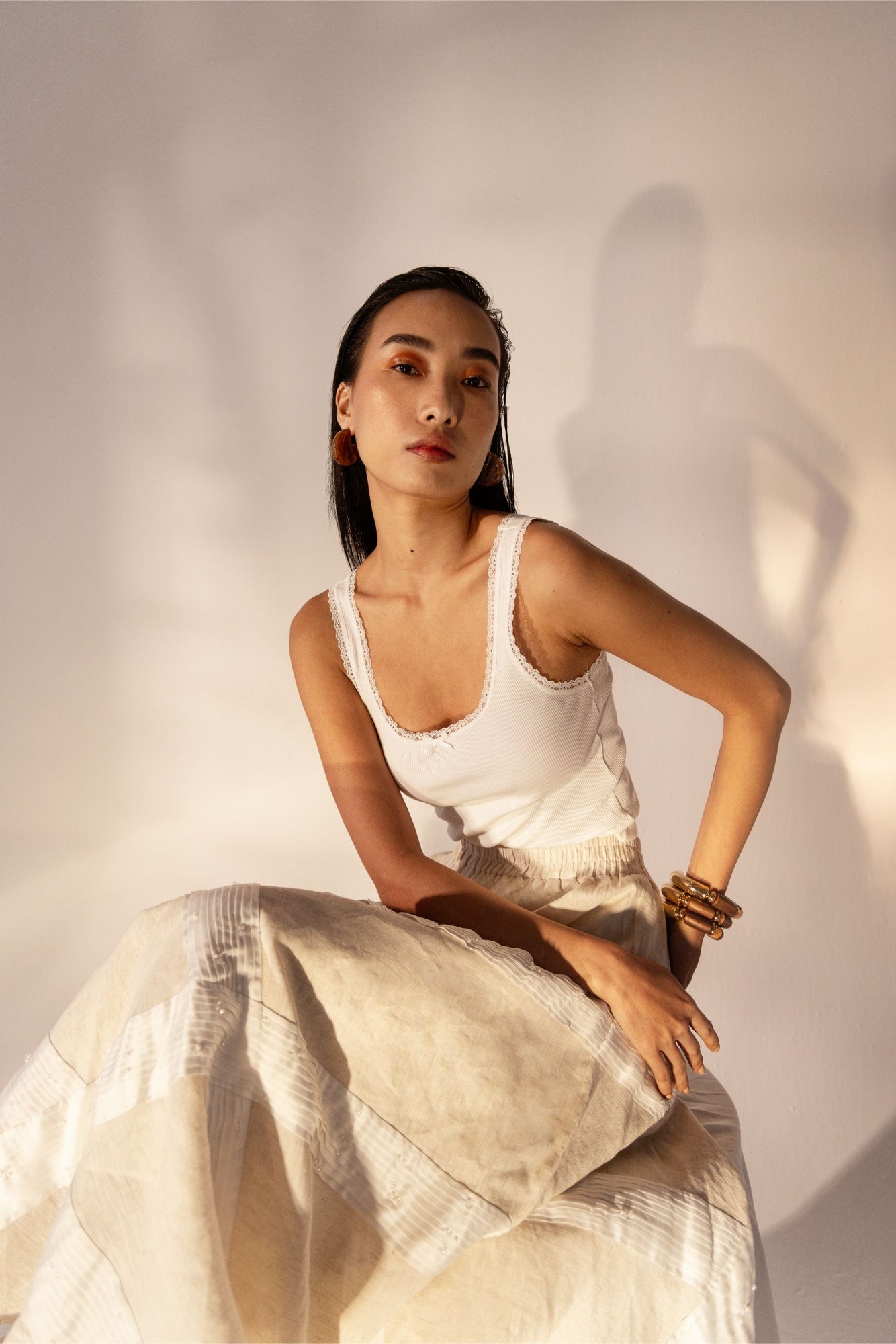 Almond beige skirt with elegant tucks, handcrafted from premium fabric, exemplifying luxury womenswear by NJ3 Atelier
