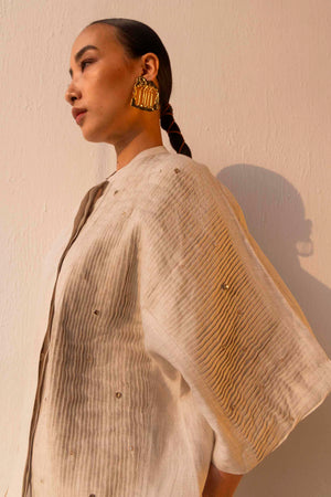 Sandstone linen shirt in premium handloom fabric, showcasing elegant tucks and a tailored silhouette, epitomizing luxury womenswear