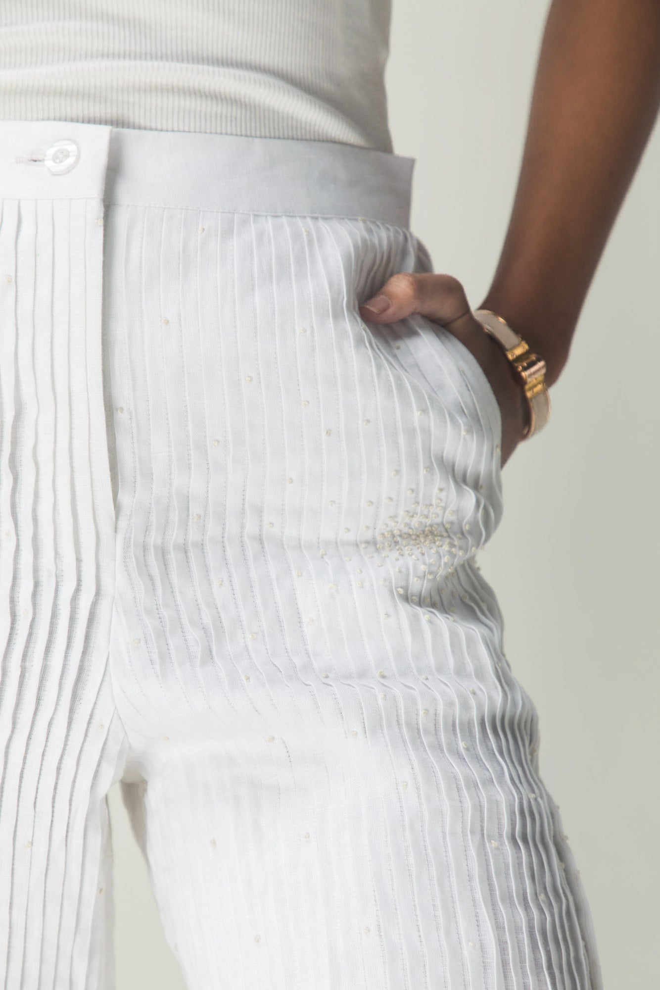 Elegant handloom shorts in soft pastel hues, showcasing intricate pleats and artisan craftsmanship, epitomizing luxury womenswear