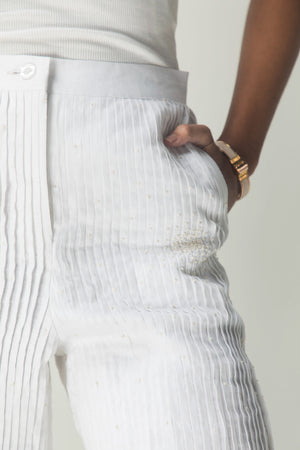 Elegant handloom shorts in soft pastel hues, showcasing intricate pleats and artisan craftsmanship, epitomizing luxury womenswear