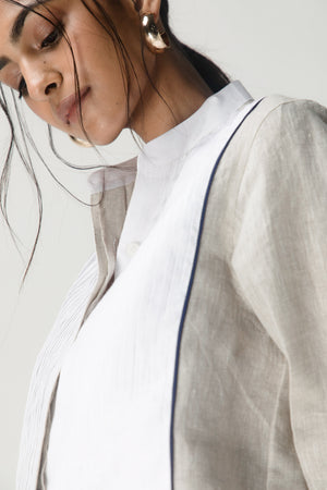 Luxurious handcrafted women's shirt in premium handloom fabric, showcasing intricate artisan stitching and elegant silhouette in brick red