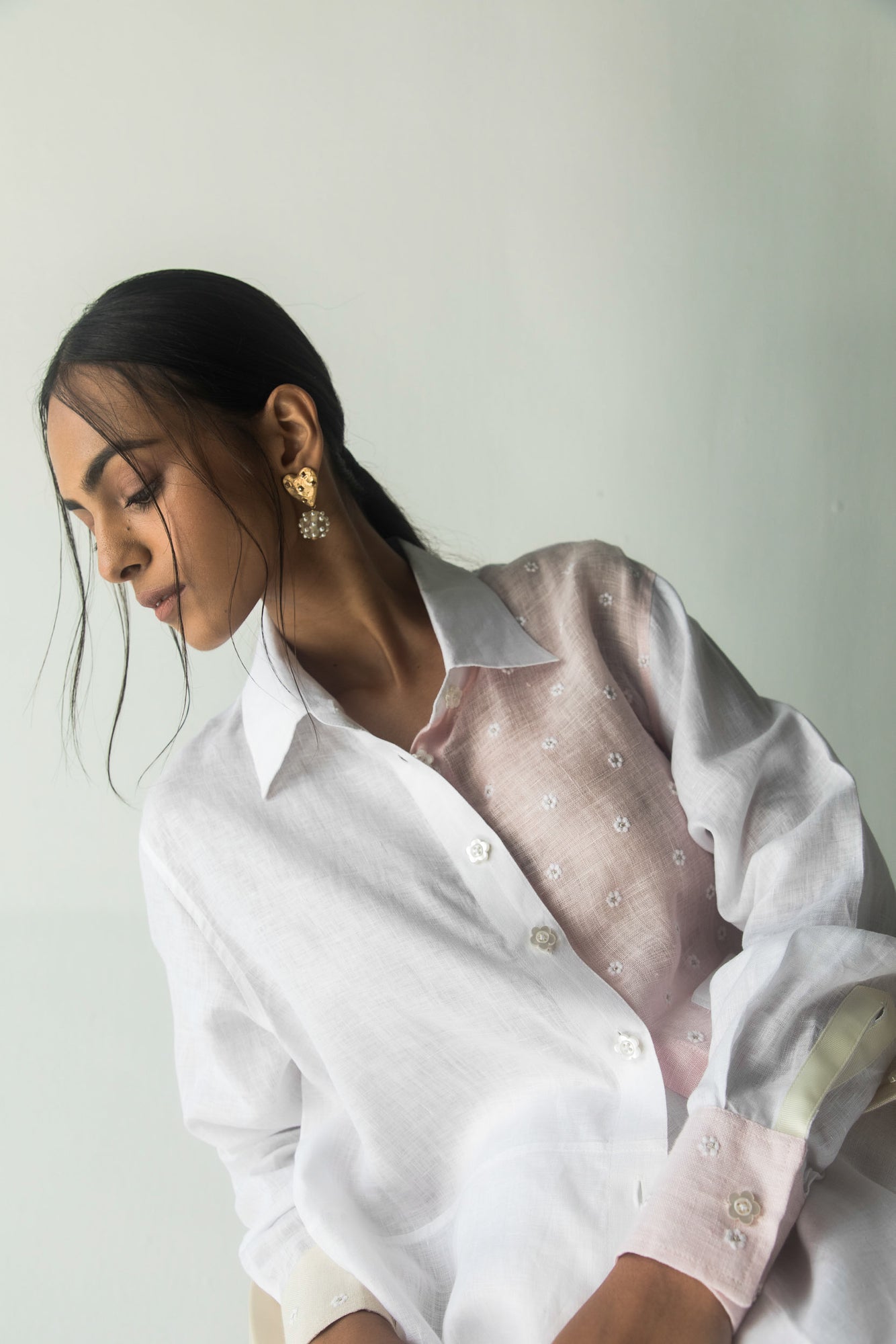 Exquisite handcrafted white shirt with artisan floral patterns, premium fabric, and elegant silhouette, epitomizing luxury womenswear
