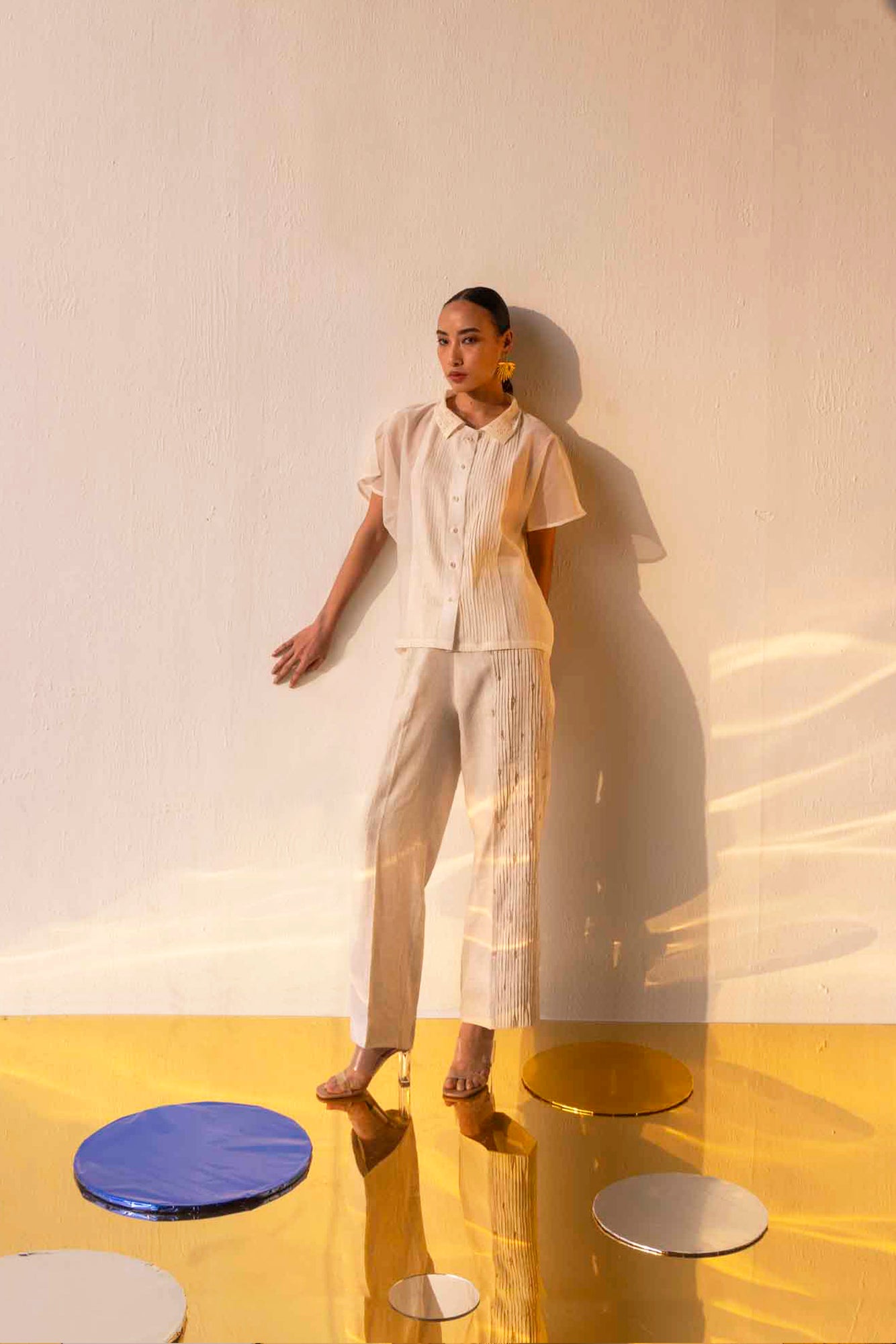 Beige linen pants with side pleats, embellished glass crystals, straight fit, elasticated back waist, and side pockets; artisan-made luxury