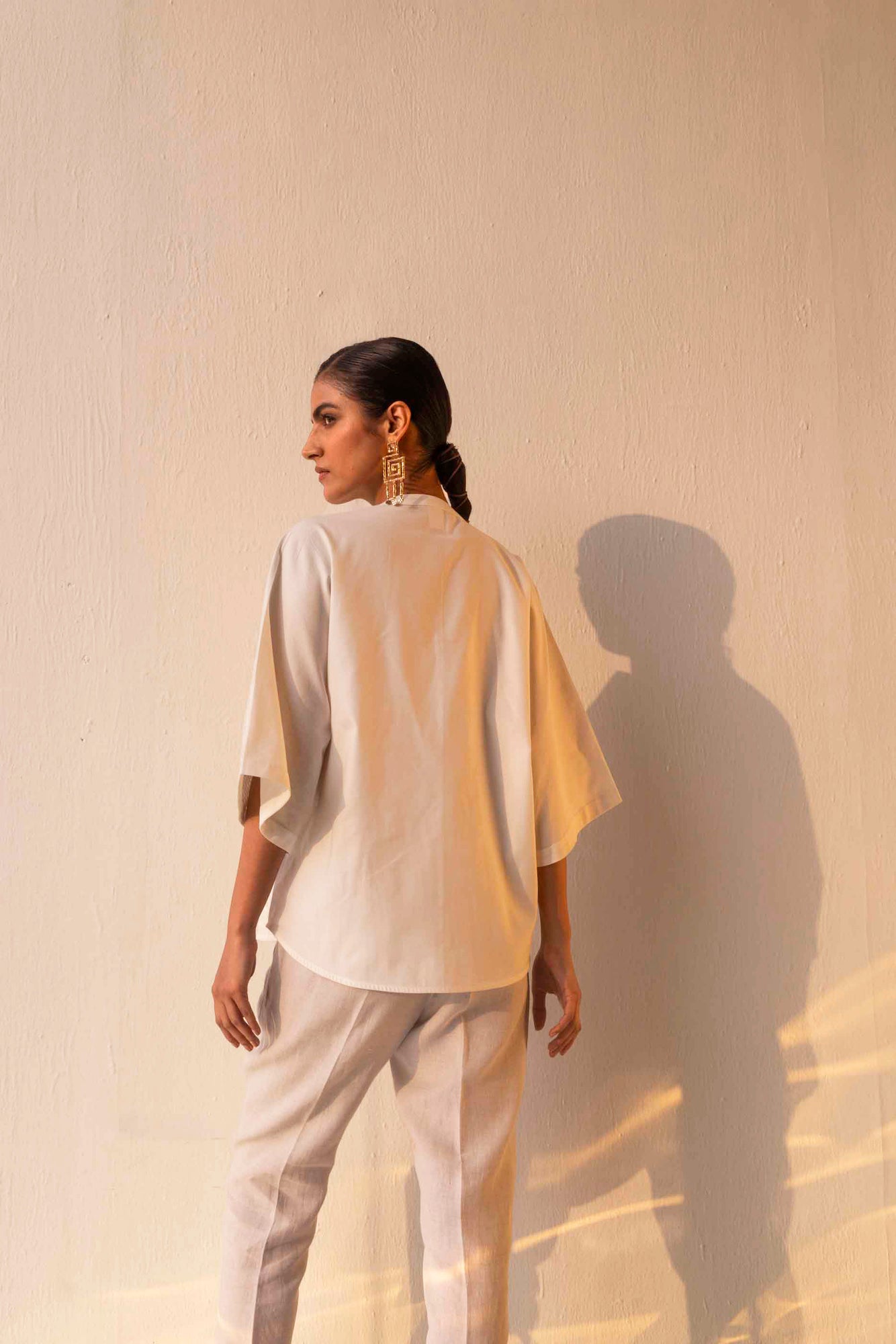 Elegant close-up of the Blanca Pleated Shirt, showcasing its artisan-crafted pleats and luxurious handloom fabric in a refined silhouette