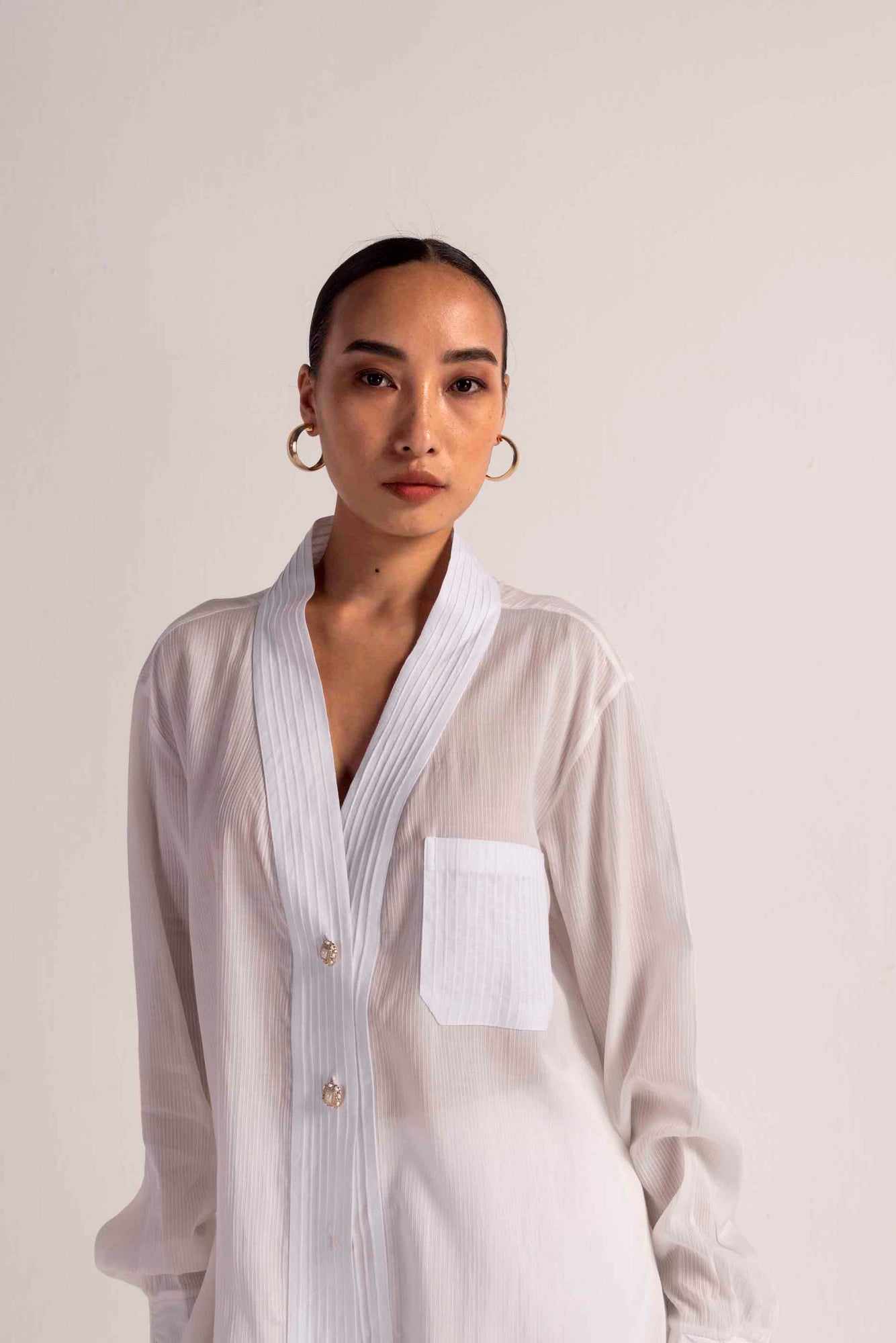 Elegant Valencia Tuck Shirt in handloom fabric, showcasing a refined silhouette and intricate artisan craftsmanship in luxury womenswear