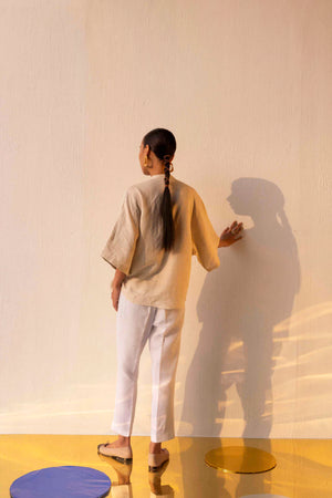 Close-up of the sandstone linen shirt, showcasing its handloom texture and artisanal craftsmanship, epitomizing luxury womenswear elegance