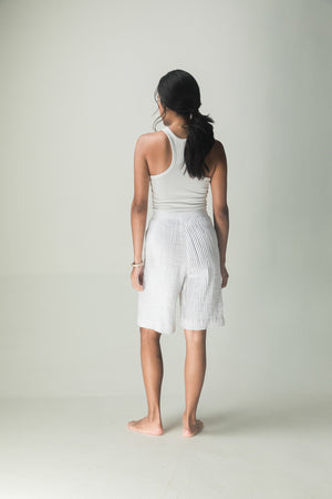 Luxurious handloom pleat shorts in rich navy, showcasing artisan craftsmanship and premium fabric for an elegant, timeless silhouette