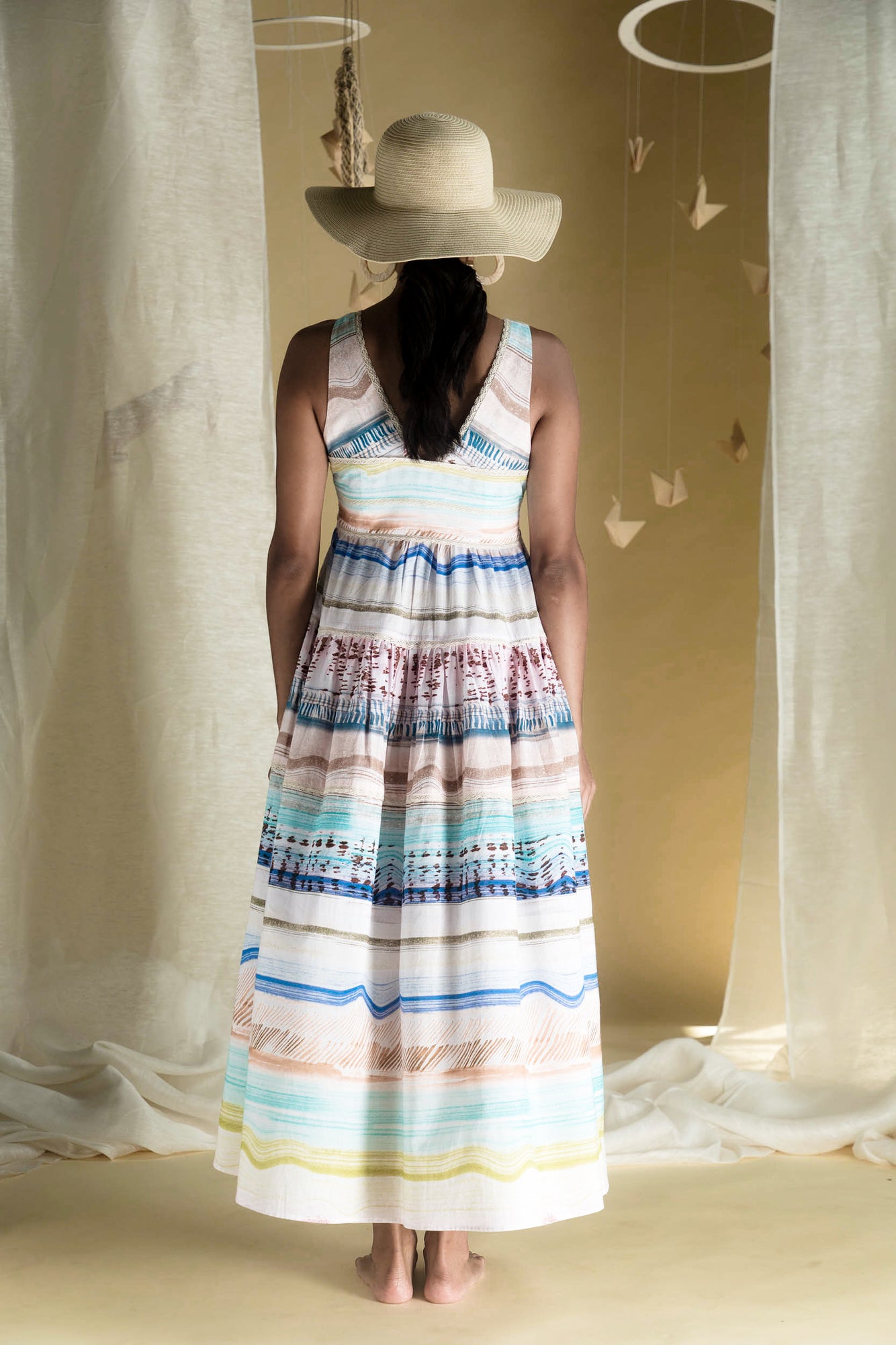 Side view of the Moana Long Dress in luxurious handloom fabric, showcasing its elegant silhouette and exquisite artisan craftsmanship