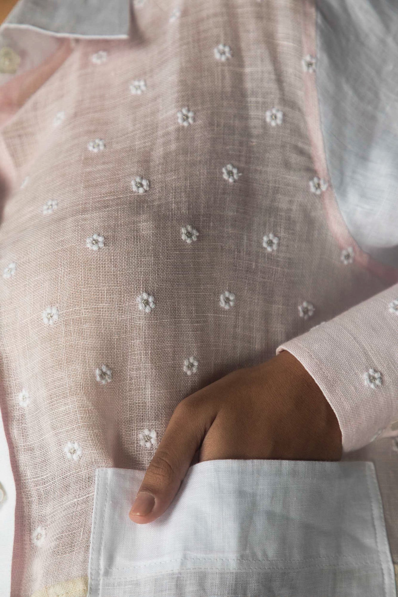 Close-up of the handcrafted white shirt with intricate handloom patterns, showcasing NJ3 Atelier's luxury artisan-made womenswear