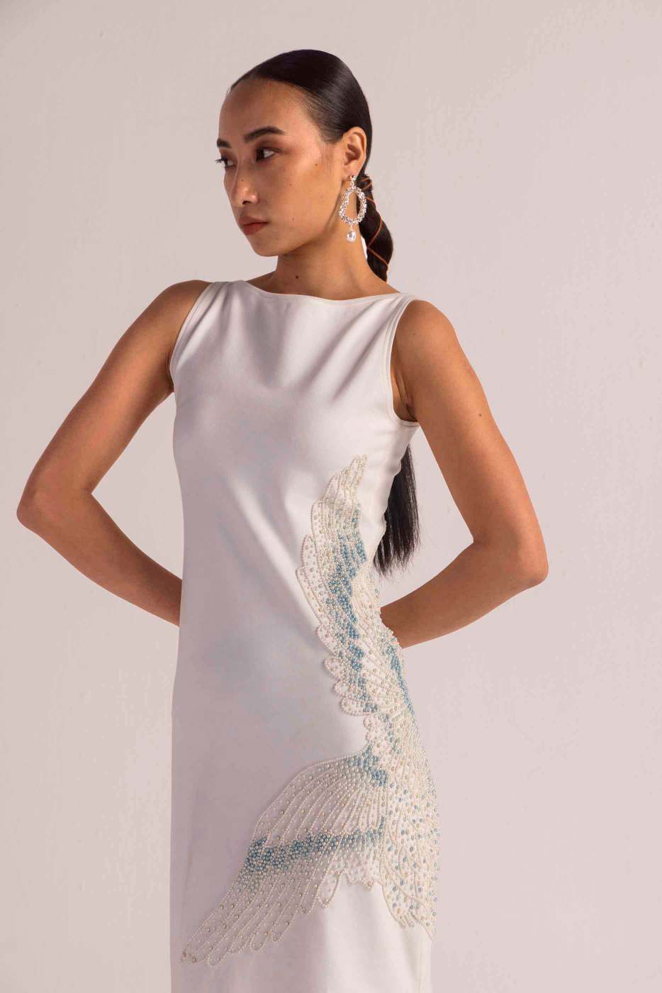 Close-up of the sea-shell pearl dress showcasing its luxurious handloom fabric and intricate artisan-crafted details in soft, elegant hues