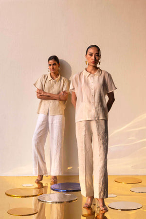 Elegant golden pleated trousers in premium fabric, showcasing NJ3 Atelier's artisan craftsmanship and luxury womenswear design