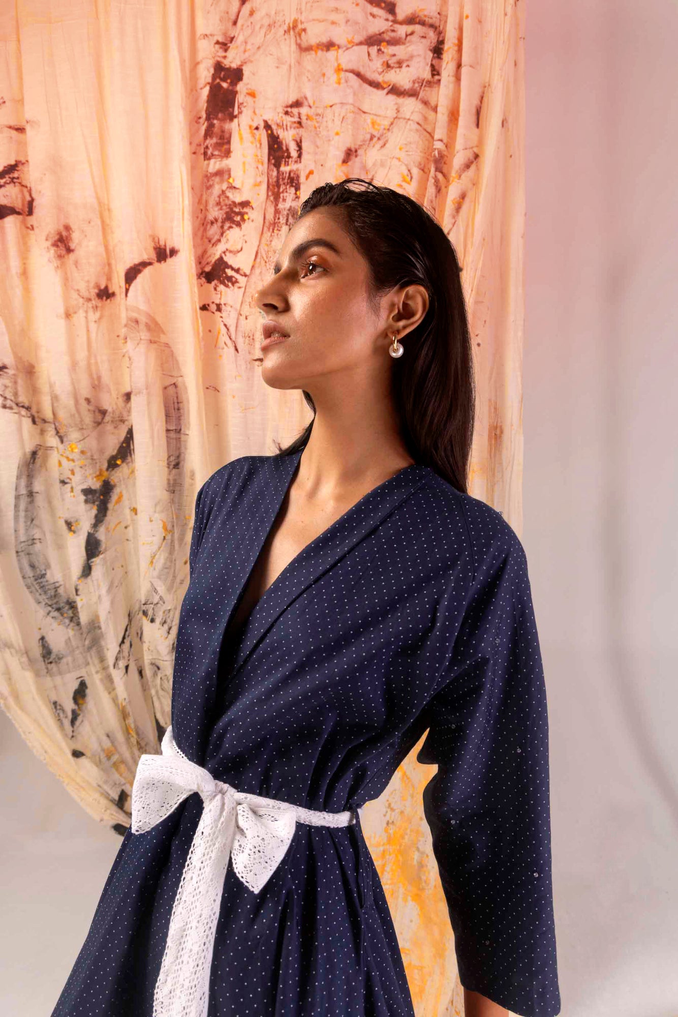 Close-up of azure satin dress showcasing luxurious handloom fabric and intricate dot pattern, epitomizing NJ3 Atelier's artisan craftsmanship