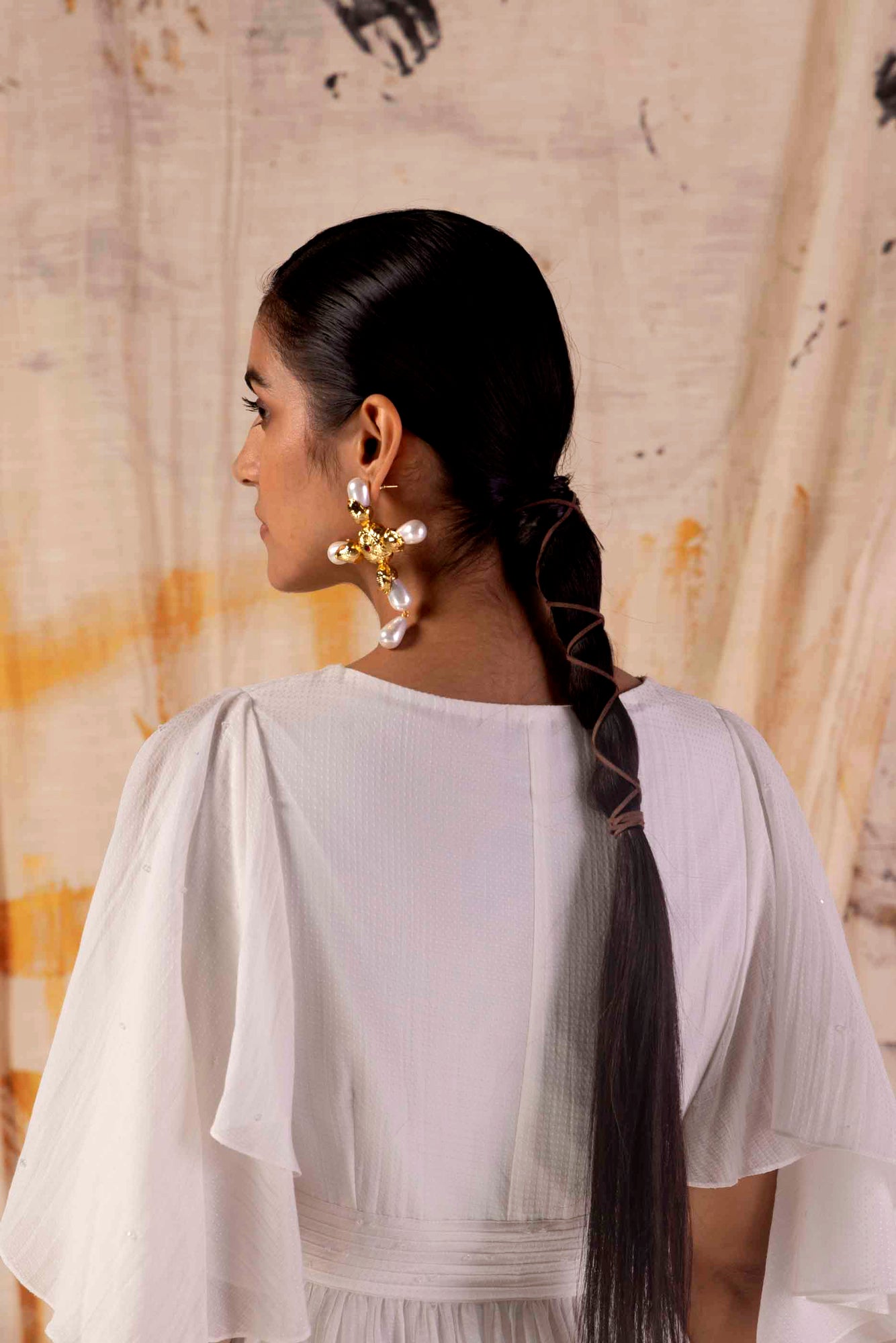 Valencia Fluid Dress in rich silk, showcasing a flowing silhouette with intricate handloom details, epitomizing luxury womenswear craftsmanship