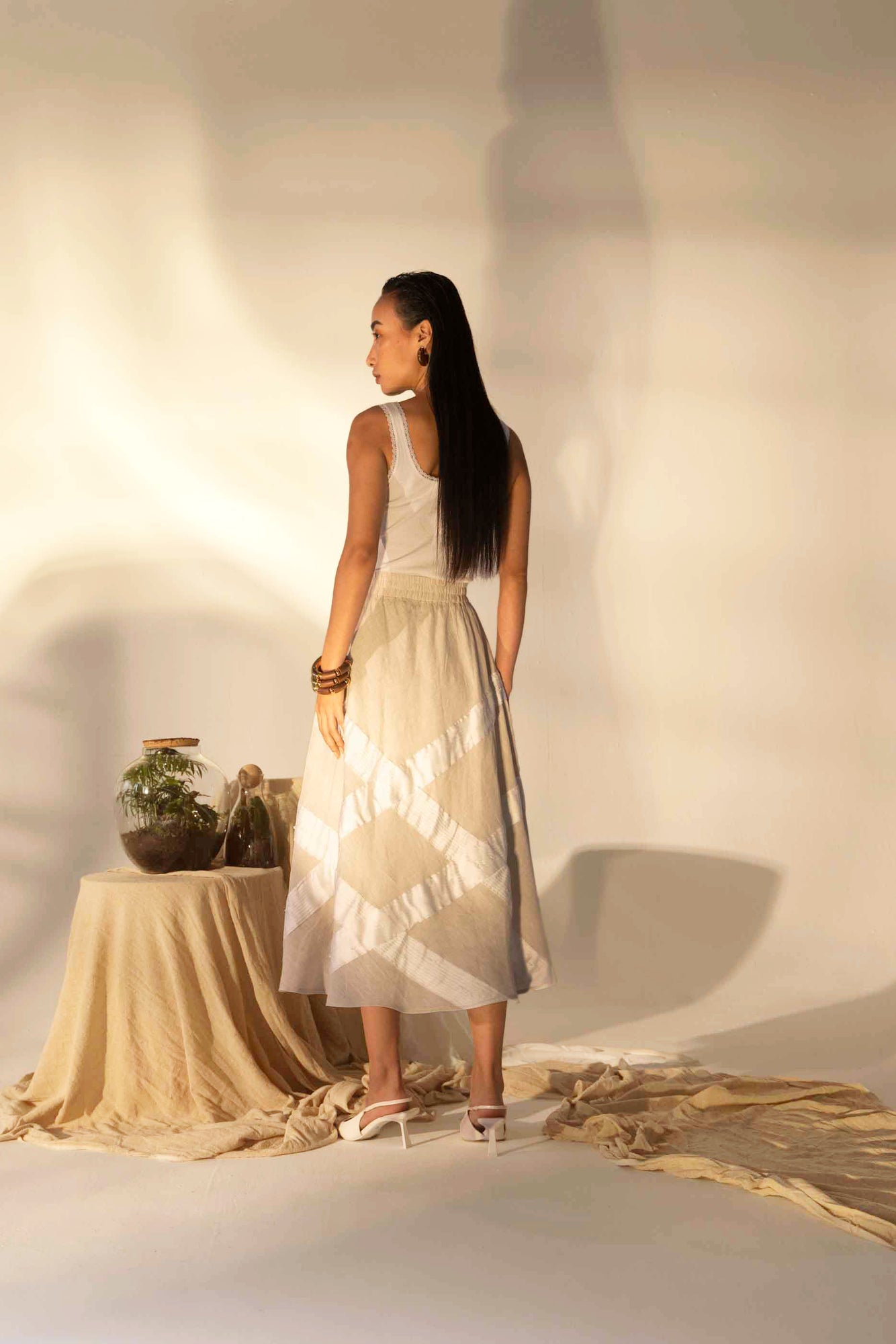 Elegant almond beige skirt in premium handloom fabric, showcasing a tailored silhouette with artisan-crafted tucks for luxury appeal