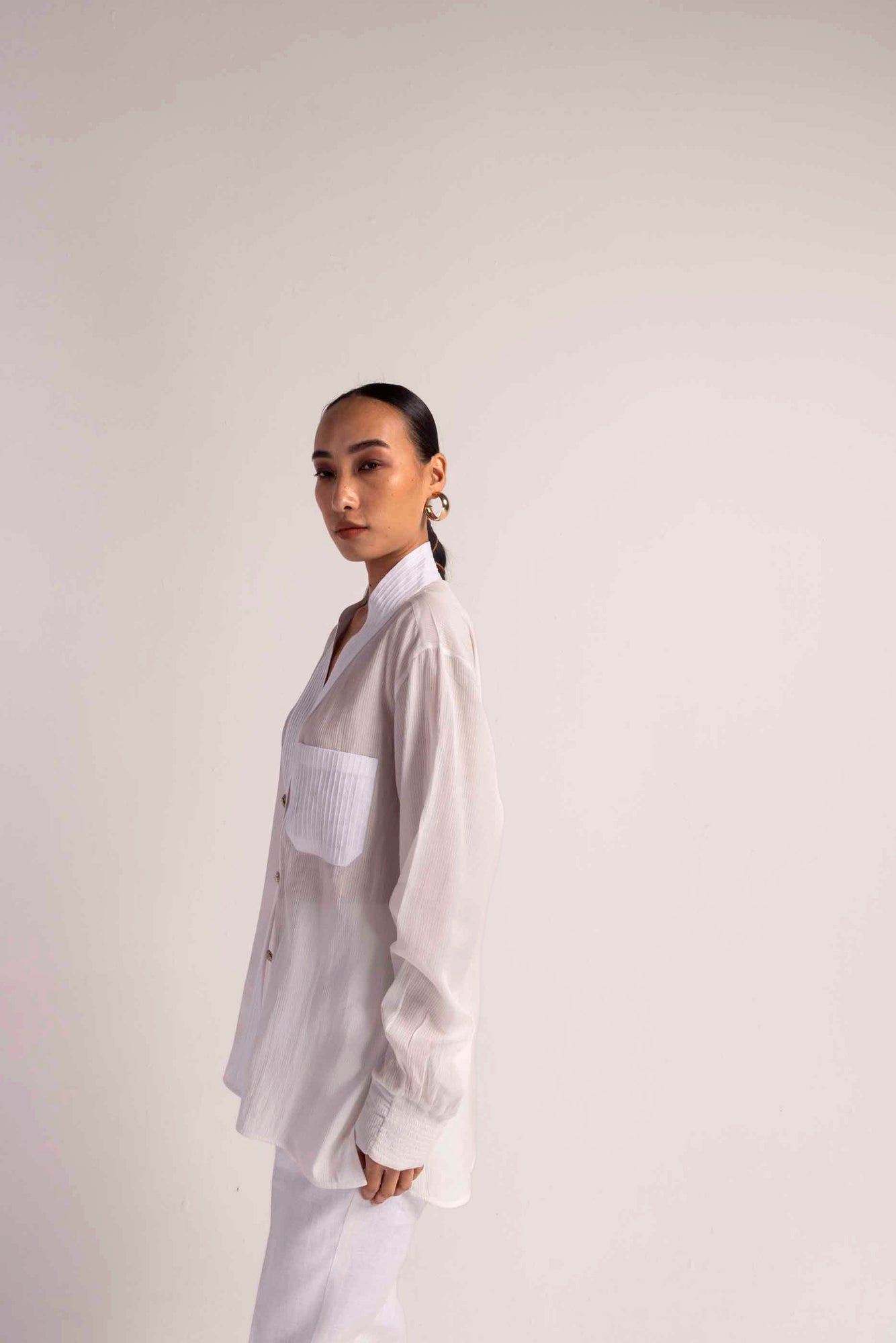 Elegant Valencia Tuck Shirt in soft handloom fabric, showcasing a refined silhouette and artisan craftsmanship for luxury womenswear