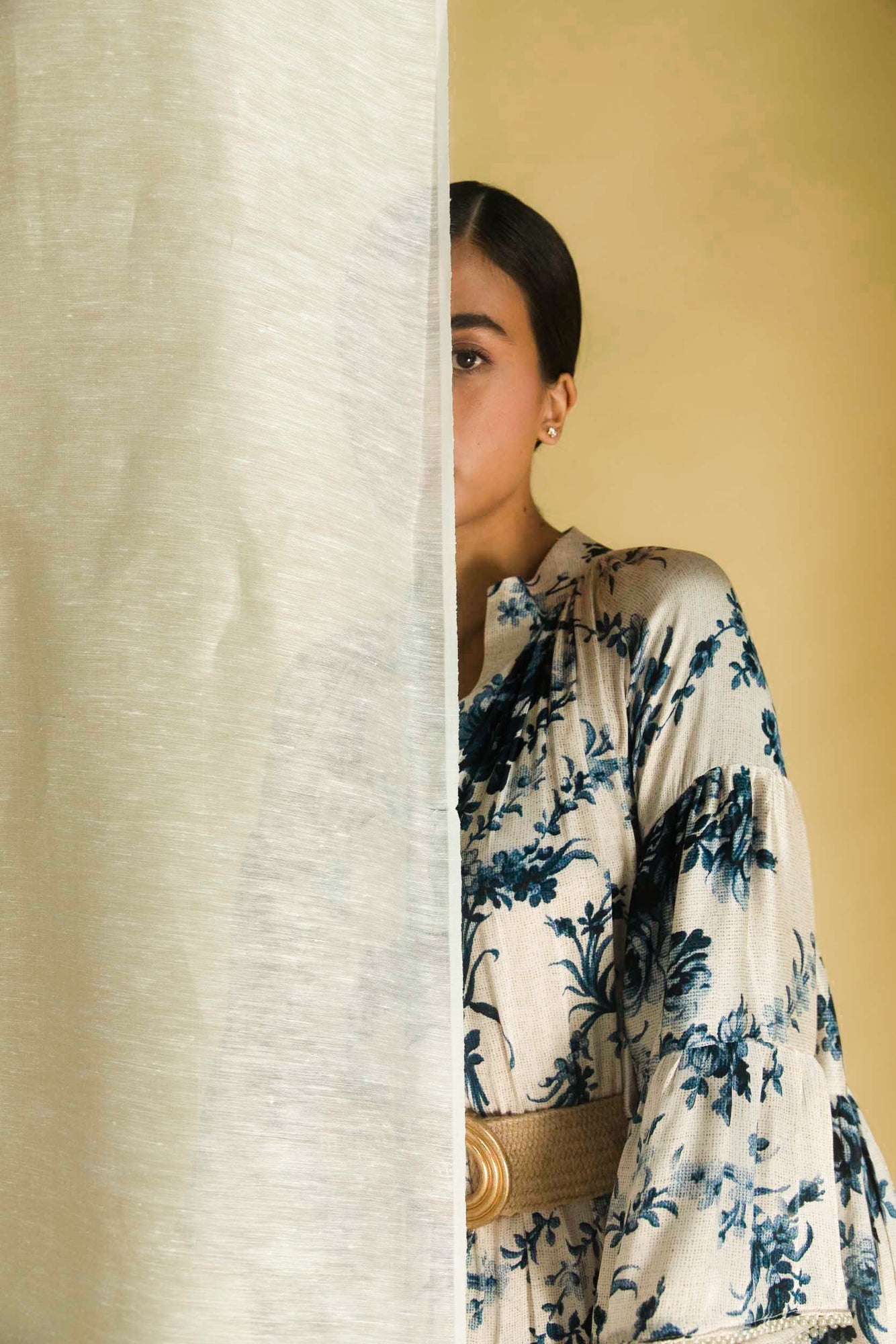 Close-up of the luxurious handloom fabric and intricate embroidery detail on the artisan-made blue bell dress by NJ3 Atelier