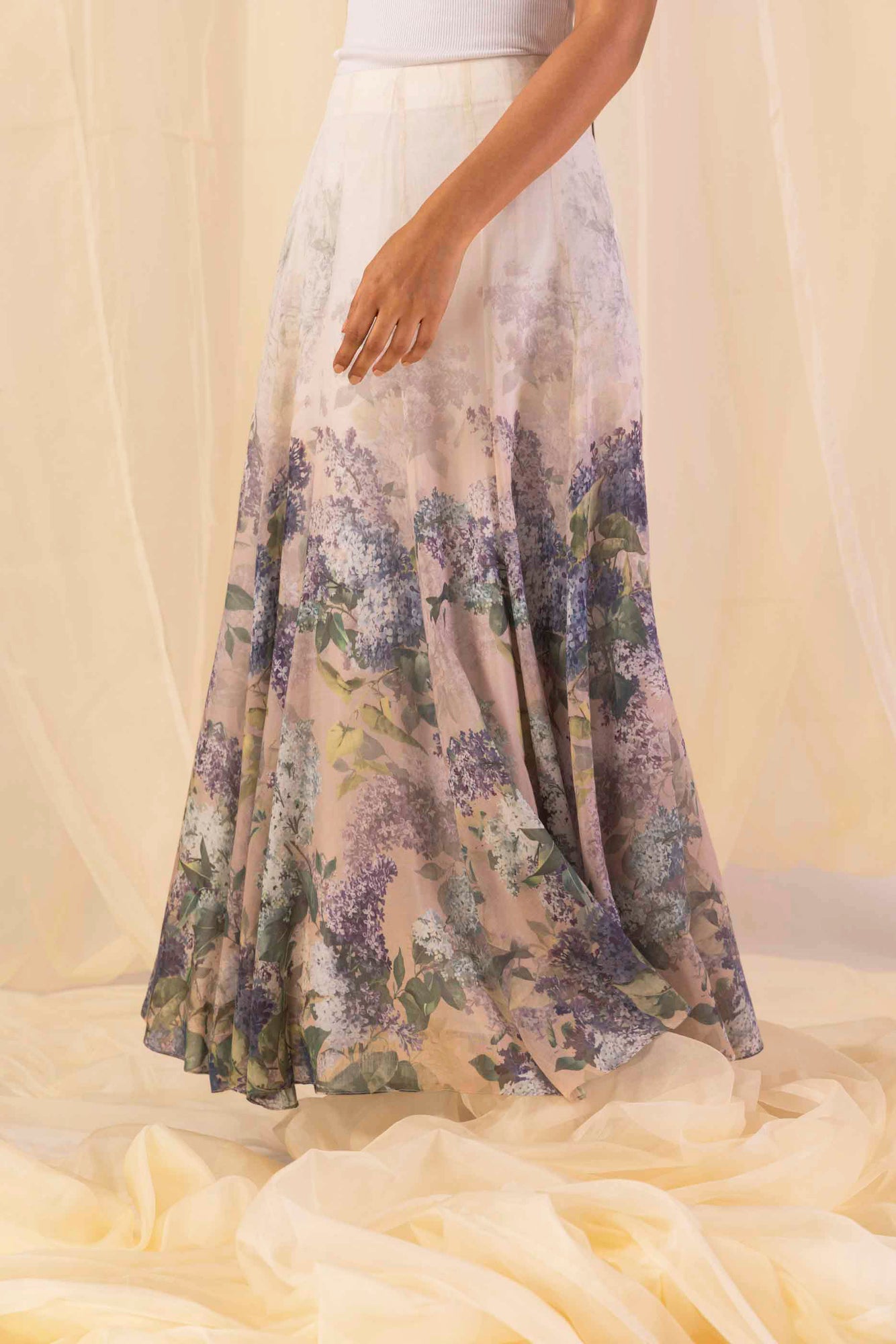 Close-up of the handloomed hydra-hues flow skirt, showcasing its luxurious drape and intricate artisan-crafted patterns in vibrant tones