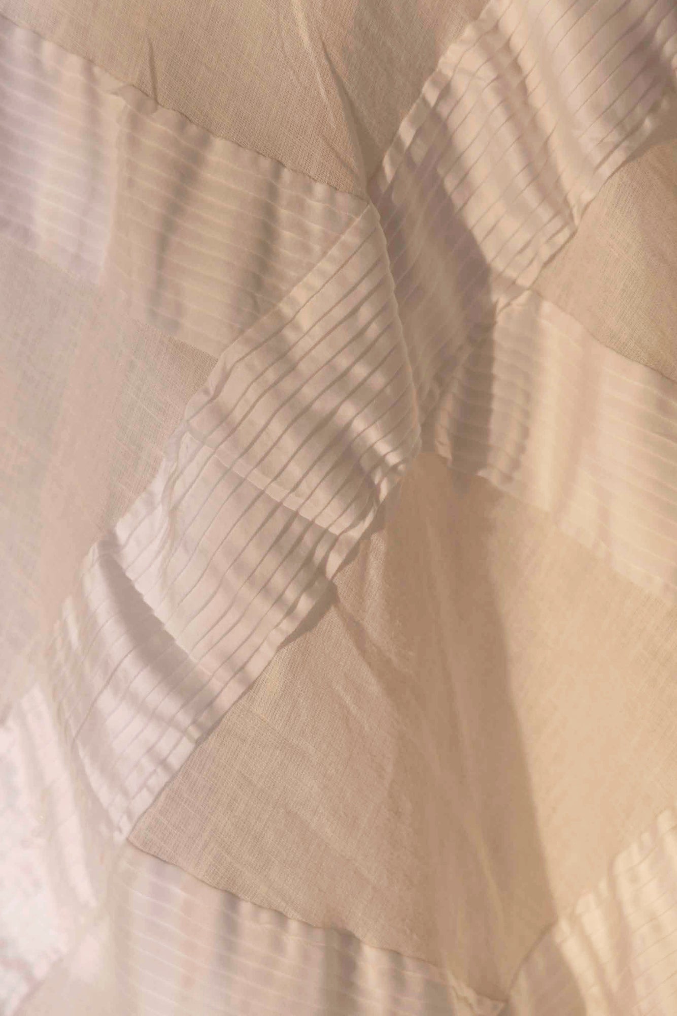Handcrafted pearl white skirt in premium fabric, showcasing a luxurious silhouette, epitomizing NJ3 Atelier's artisan craftsmanship
