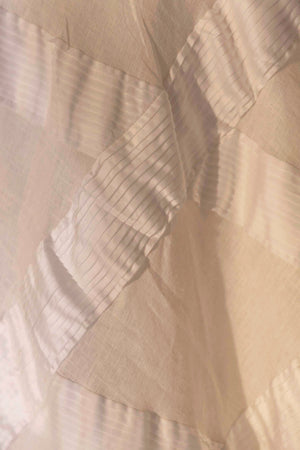 Handcrafted pearl white skirt in premium fabric, showcasing a luxurious silhouette, epitomizing NJ3 Atelier's artisan craftsmanship