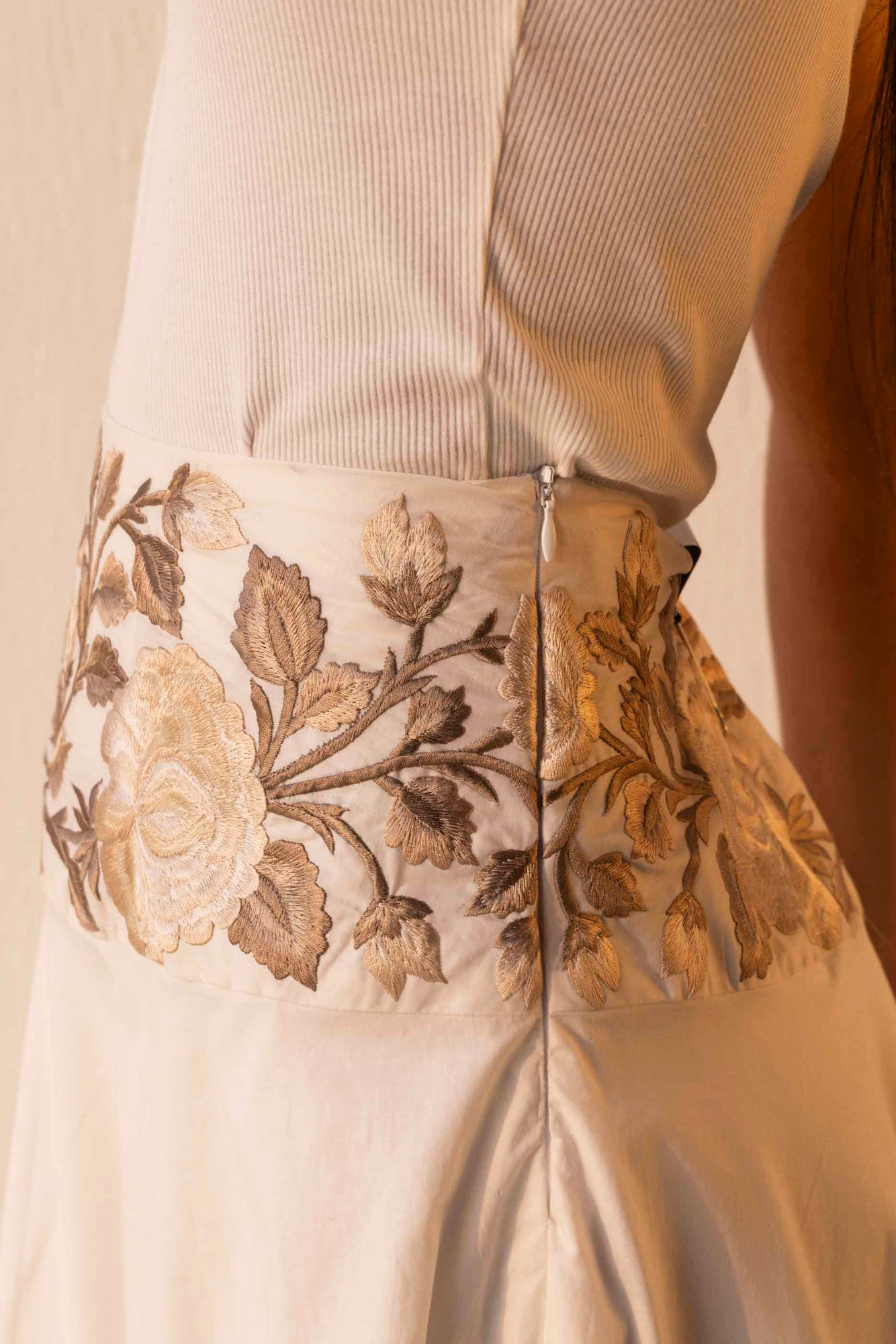 Handcrafted rich gold skirt with intricate swirl patterns, showcasing luxury womenswear elegance and premium artisan-made fabric