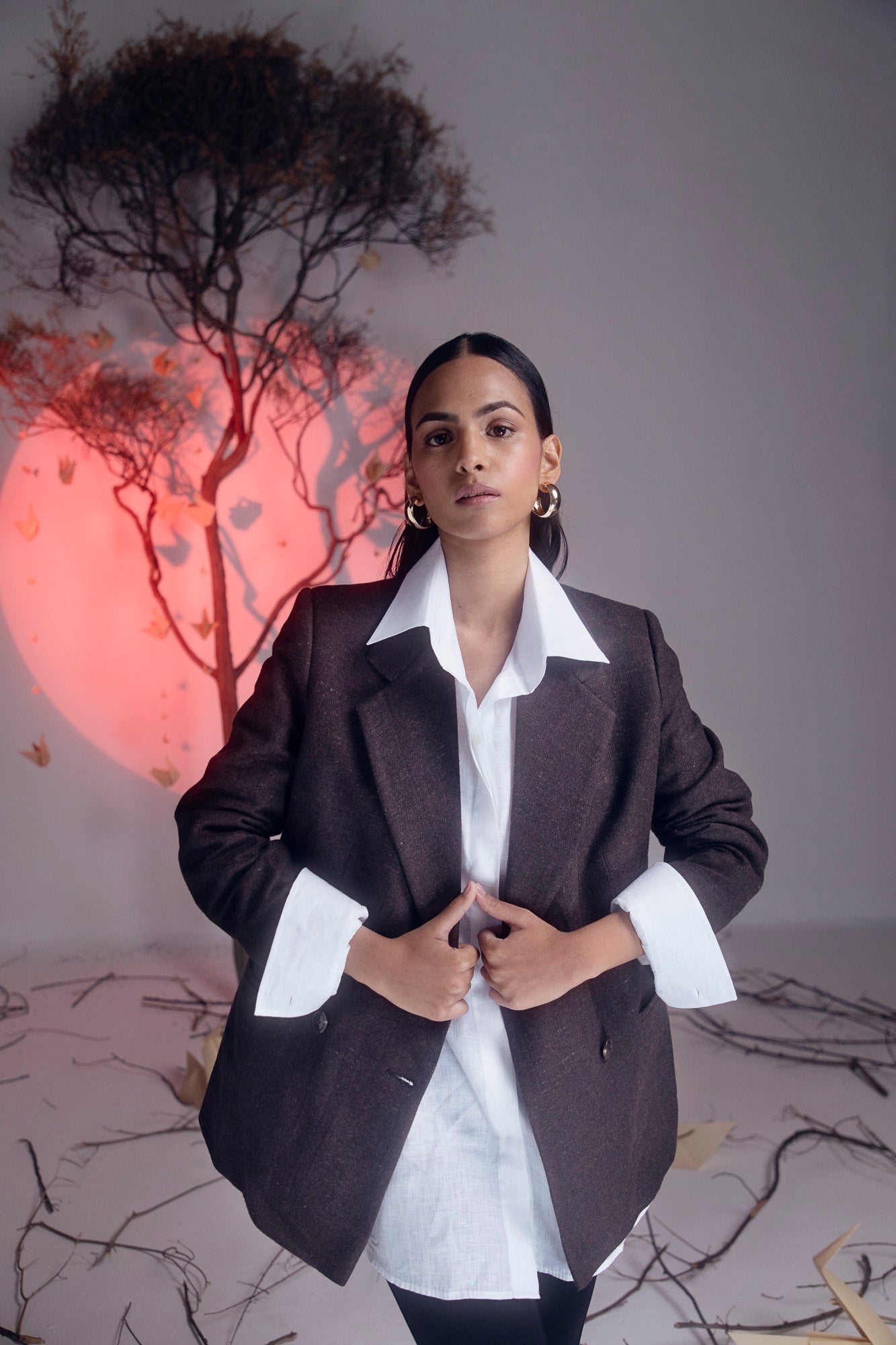 Handcrafted brown blazer in pure woolen herringbone, lined with silk taffeta, showcasing luxury womenswear craftsmanship
