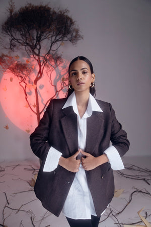 Handcrafted brown blazer in pure woolen herringbone, lined with silk taffeta, showcasing luxury womenswear craftsmanship